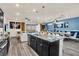 Modern kitchen with a large island, granite countertops, and stainless steel appliances at 3032 Mahalo Dr, Davenport, FL 33897