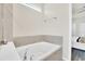 Relaxing bathroom featuring an oval soaking tub and tile surround at 3032 Mahalo Dr, Davenport, FL 33897