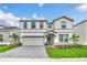 Two-story home with gray siding and gray paved driveway at 3032 Mahalo Dr, Davenport, FL 33897