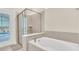 Bathroom with a large soaking tub and walk-in shower at 3032 Mahalo Dr, Davenport, FL 33897