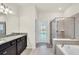 Elegant bathroom with double sinks, granite countertop, and a large shower at 3032 Mahalo Dr, Davenport, FL 33897