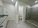 Modern bathroom with granite countertop and walk-in shower at 42 Argos Ave, Orlando, FL 32811