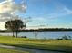 Scenic view of a lake with lush green grass and trees at 4803 Apple Blossom Ln # 4803, St Cloud, FL 34771