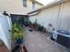 Private backyard patio with potted plants and AC unit at 4803 Apple Blossom Ln # 4803, St Cloud, FL 34771