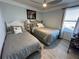 Guest bedroom with twin and full-size beds and ceiling fan at 4803 Apple Blossom Ln # 4803, St Cloud, FL 34771