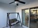 Relaxing enclosed patio with a swing and sliding glass doors at 4803 Apple Blossom Ln # 4803, St Cloud, FL 34771