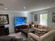 Comfortable living room with a large TV and a cozy seating area at 4803 Apple Blossom Ln # 4803, St Cloud, FL 34771