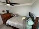 Bright bedroom with double bed, dresser, and ceiling fan at 4803 Apple Blossom Ln # 4803, St Cloud, FL 34771