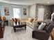 Spacious living room featuring a large sectional sofa and stone accent wall at 4803 Apple Blossom Ln # 4803, St Cloud, FL 34771