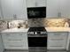 Modern kitchen with white cabinets and stainless steel appliances at 4803 Apple Blossom Ln # 4803, St Cloud, FL 34771