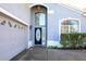 Front entrance of a house with a black door and a gray exterior at 498 Freeman St, Longwood, FL 32750