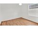 Simple bedroom with light walls, wood floors, and a window with blinds at 6214 Stevenson Dr # 303, Orlando, FL 32835