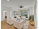 Bright living room with white sectional sofa and wood floors at 6214 Stevenson Dr # 303, Orlando, FL 32835