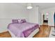 Purple bedding and wood floors in this well lit bedroom at 6214 Stevenson Dr # 303, Orlando, FL 32835