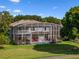 Two-story house with pool and screened enclosure, surrounded by lush landscaping at 9918 Turtle Bay Ct, Orlando, FL 32832