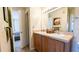 Double vanity bathroom with wood cabinets and large mirror at 1065 S Hiawassee Rd # 1428, Orlando, FL 32835