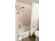 Bathroom with shower/tub, tile surround and floral shower curtain at 1065 S Hiawassee Rd # 1428, Orlando, FL 32835