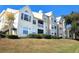 Tan colored multi-unit building with grassy lawn at 1065 S Hiawassee Rd # 1428, Orlando, FL 32835