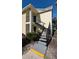 Exterior view of a yellow building with a gray metal staircase at 1065 S Hiawassee Rd # 1428, Orlando, FL 32835