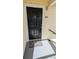 Welcoming condo entrance with a black door and a welcome mat at 1065 S Hiawassee Rd # 1428, Orlando, FL 32835