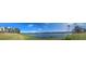 Panoramic view of a lake with condo building and lush landscaping at 1065 S Hiawassee Rd # 1428, Orlando, FL 32835