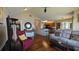 Living room with hardwood floors, open kitchen, and comfy seating at 1065 S Hiawassee Rd # 1428, Orlando, FL 32835