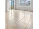 Living room with tile floors and sliding glass doors at 1209 Limbali St, Mount Dora, FL 32757