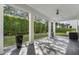 Spacious covered patio with tile flooring and lush landscaping at 1429 Chapman Cir, Winter Park, FL 32789