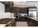 Sleek kitchen with dark cabinetry, stainless steel appliances and gas cooktop at 1429 Chapman Cir, Winter Park, FL 32789