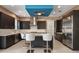 Modern kitchen with dark cabinetry, stainless steel appliances, and a granite island at 1429 Chapman Cir, Winter Park, FL 32789