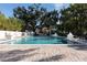 Refreshing community pool with gazebo and lush trees at 1429 Chapman Cir, Winter Park, FL 32789