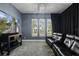 Home theater with large screen TV, comfortable seating, and neutral decor at 1429 Chapman Cir, Winter Park, FL 32789