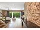 Open living area with stone wall and backyard access at 1429 Chapman Cir, Winter Park, FL 32789