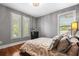 Bright bedroom with hardwood floors, plantation shutters, and neutral decor at 1429 Chapman Cir, Winter Park, FL 32789