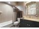 Bathroom with granite countertop, tiled shower, and updated fixtures at 1429 Chapman Cir, Winter Park, FL 32789