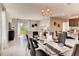 Spacious dining area with glass table and chairs, adjacent to living room and kitchen at 1602 Bull Hill Rd, Kissimmee, FL 34744