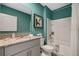 Modern bathroom with a teal vanity, granite countertop, and a white subway tiled shower at 1659 Three Bars Rd, Kissimmee, FL 34744