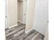 Hallway with light walls, white doors, and gray vinyl plank flooring at 2642 Magnolia Cir, Lake Wales, FL 33898