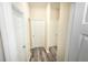 Hallway with light walls, white doors, and gray vinyl plank flooring at 2642 Magnolia Cir, Lake Wales, FL 33898