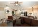 Virtually staged living room featuring a brown leather couch and wood floors at 2642 Magnolia Cir, Lake Wales, FL 33898