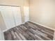 Bedroom with wood-look floors and double closets at 2642 Magnolia Cir, Lake Wales, FL 33898