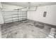 Empty attached garage with a light gray floor and an automatic garage door at 2642 Magnolia Cir, Lake Wales, FL 33898