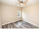 Simple bedroom with light walls, gray vinyl plank flooring, and a ceiling fan at 2642 Magnolia Cir, Lake Wales, FL 33898