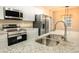 Kitchen boasts stainless steel appliances and granite countertops at 2642 Magnolia Cir, Lake Wales, FL 33898