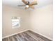 Bedroom with wood-look floors and a window at 2642 Magnolia Cir, Lake Wales, FL 33898