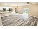 Spacious living room with light gray vinyl plank flooring and sliding glass doors at 2642 Magnolia Cir, Lake Wales, FL 33898