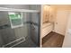 Bathroom with walk-in shower, gray tile, and modern vanity at 2642 Magnolia Cir, Lake Wales, FL 33898