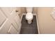 Small bathroom with toilet and dark gray tile flooring at 2642 Magnolia Cir, Lake Wales, FL 33898