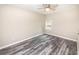 Bedroom with ceiling fan, large window, and wood-look flooring at 2642 Magnolia Cir, Lake Wales, FL 33898