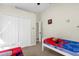 Bright bedroom with twin beds, ample closet space, and playful decor at 2660 Oneida Loop, Kissimmee, FL 34747
